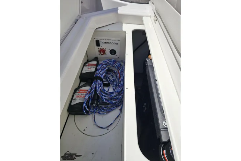 Slide: The Image of Storage compartment of 2018 Four Winns HD220 boat with ropes and equipment. - 101