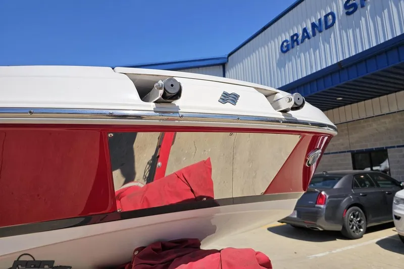 Slide: The Image of 2018 Four Winns HD220 boat at dealership, showcasing sleek red and white design. - 17