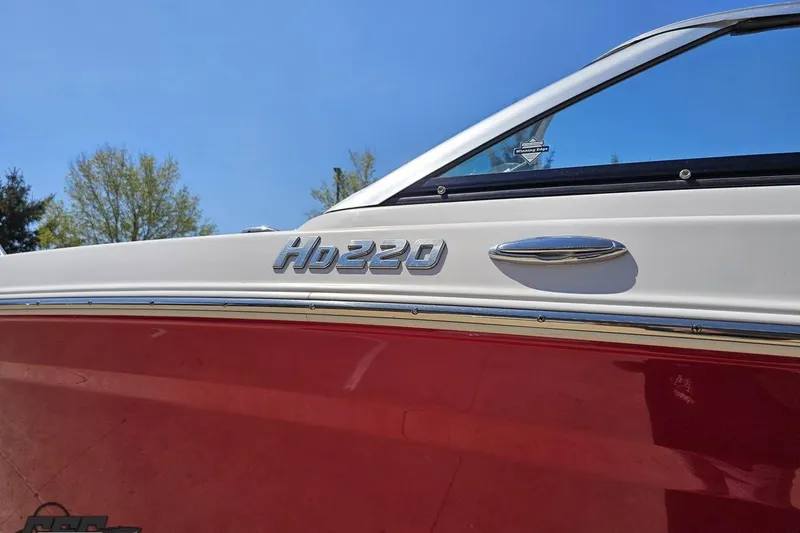 Slide: The Image of 2018 Four Winns HD220 boat side view with red and white exterior. - 26