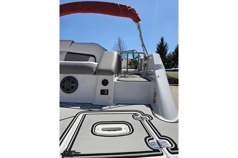 Slide: The Image of 2018 Four Winns HD220 boat interior with seating and speaker, under clear blue sky. - 37