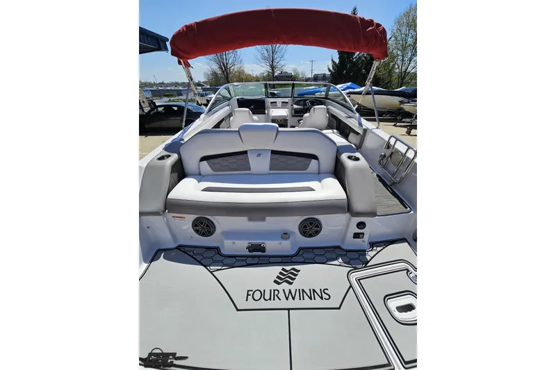 Slide: The Image of 2018 Four Winns HD220 boat interior with red canopy and spacious seating. - 39