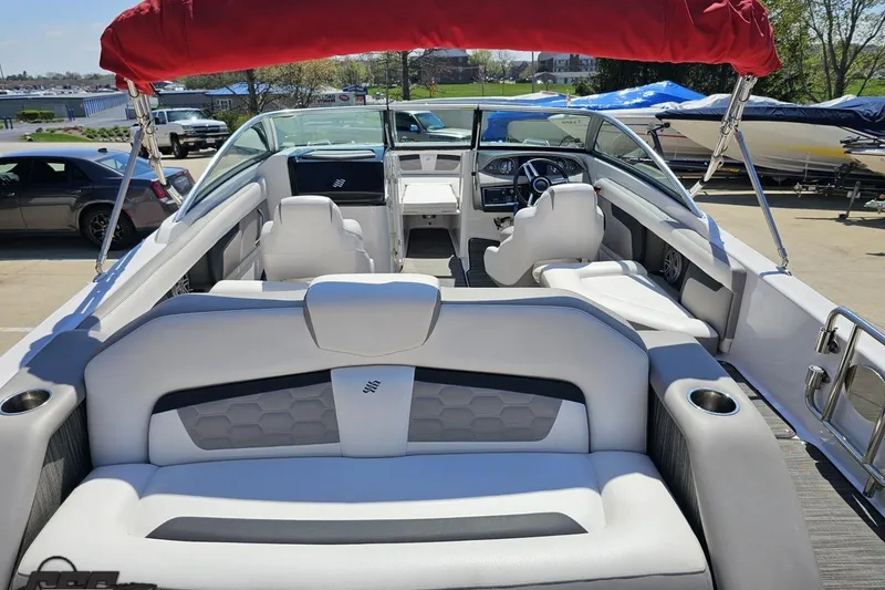 Slide: The Image of 2018 Four Winns HD220 boat interior with white seating and red canopy. - 40
