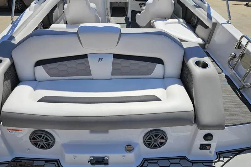Slide: The Image of 2018 Four Winns HD220 boat interior with white seating and cup holders. - 42