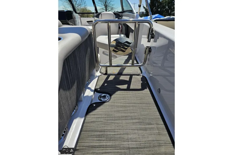 Slide: The Image of 2018 Four Winns HD220 boat interior with open gate and textured flooring. - 50