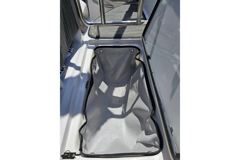 Slide: The Image of 2018 Four Winns HD220 boat storage compartment with mesh liner. - 51