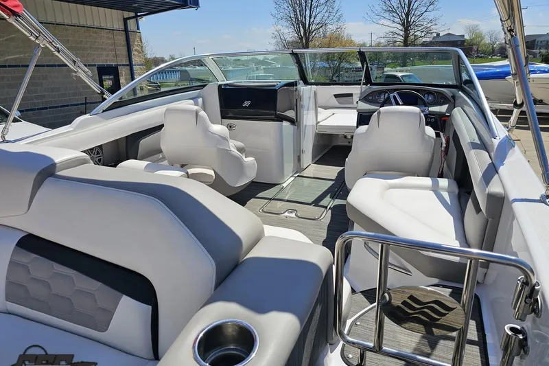 Slide: The Image of 2018 Four Winns HD220 boat interior with white seating and modern dashboard. - 52