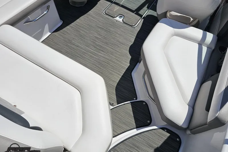 Slide: The Image of 2018 Four Winns HD220 boat interior with gray flooring and white seating. - 53