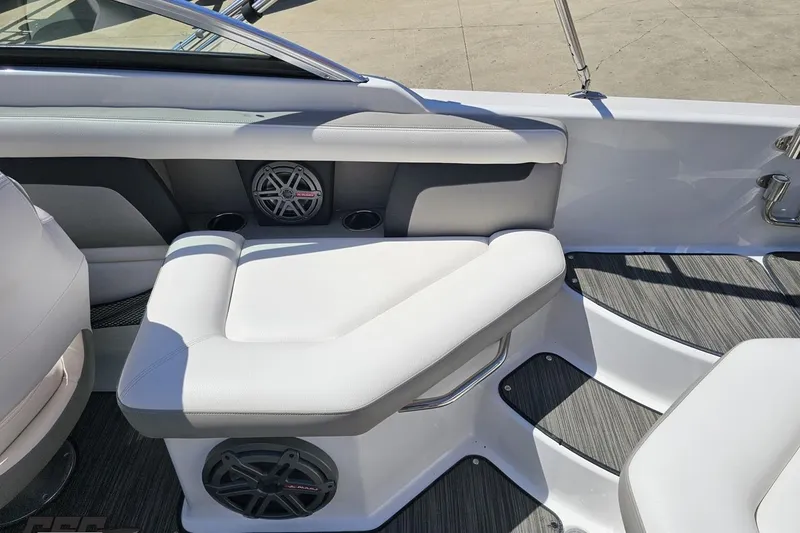 Slide: The Image of 2018 Four Winns HD220 boat interior with cushioned seating and built-in speakers. - 55