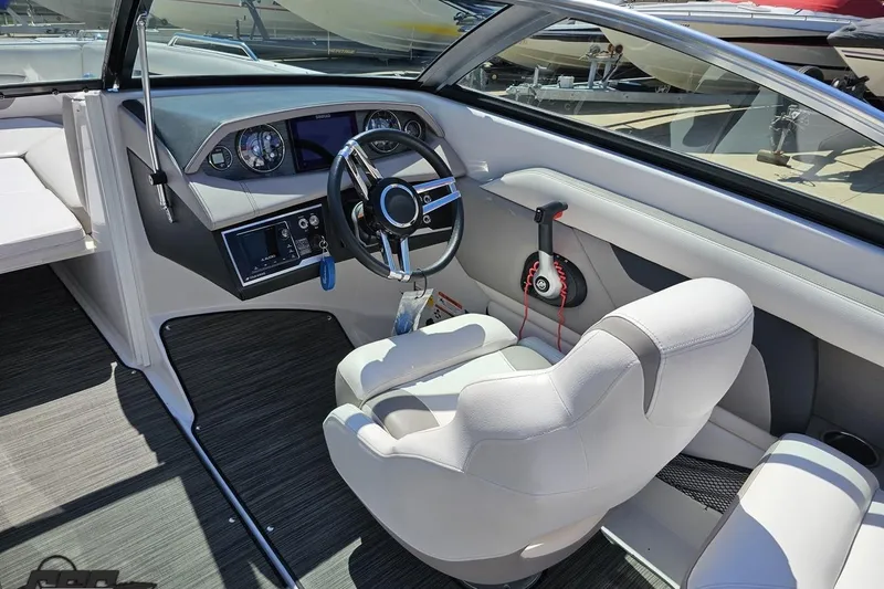 Slide: The Image of Interior of 2018 Four Winns HD220 boat with steering wheel and dashboard controls. - 56