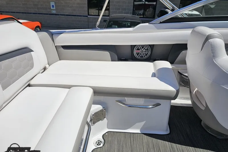 Slide: The Image of 2018 Four Winns HD220 boat interior with white seating and speaker detail. - 58