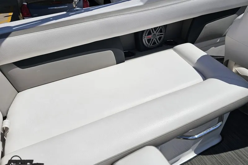 Slide: The Image of 2018 Four Winns HD220 boat interior with white seating and speaker system. - 59