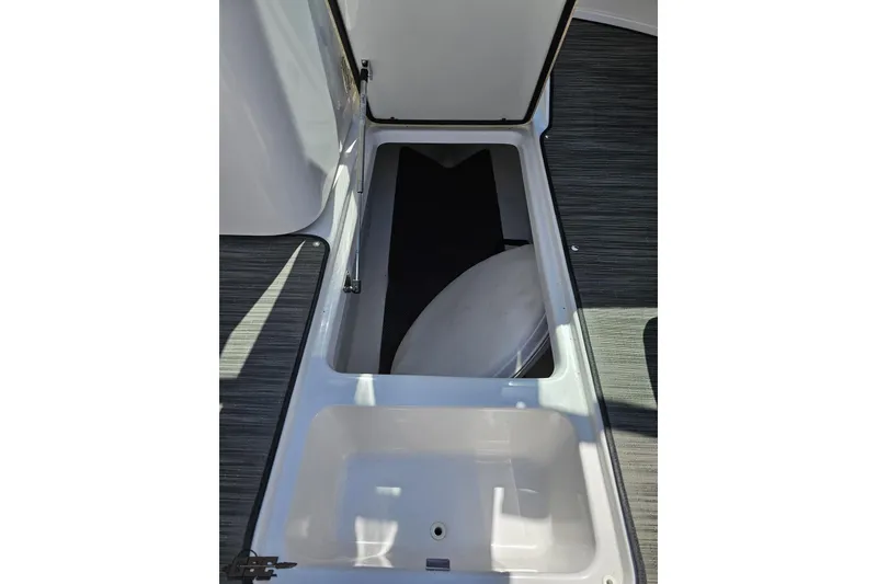 Slide: The Image of 2018 Four Winns HD220 boat storage compartment with open hatch, showcasing interior space. - 64