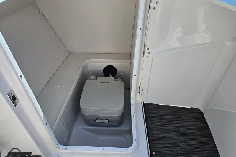 Slide: The Image of 2018 Four Winns HD220 boat interior with compact portable toilet. - 68