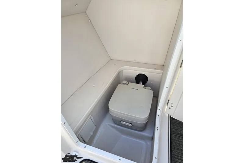 Slide: The Image of 2018 Four Winns HD220 boat interior with portable toilet in compact compartment. - 69