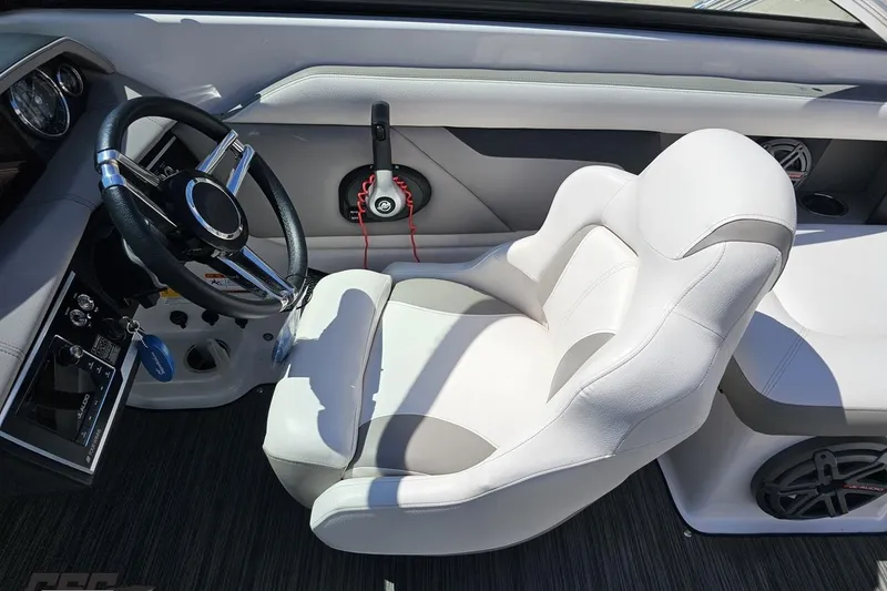 Slide: The Image of 2018 Four Winns HD220 boat interior with steering wheel and white captain's chair. - 70
