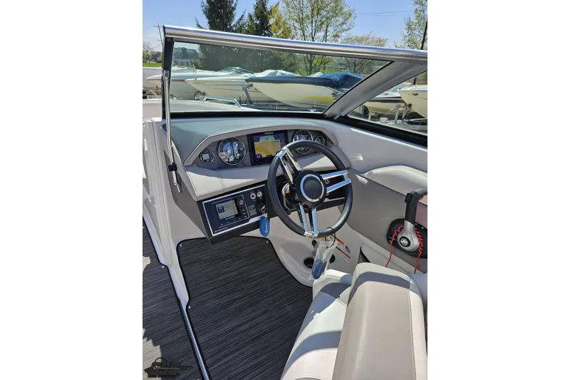 Slide: The Image of 2018 Four Winns HD220 boat cockpit with steering wheel and dashboard controls. - 72