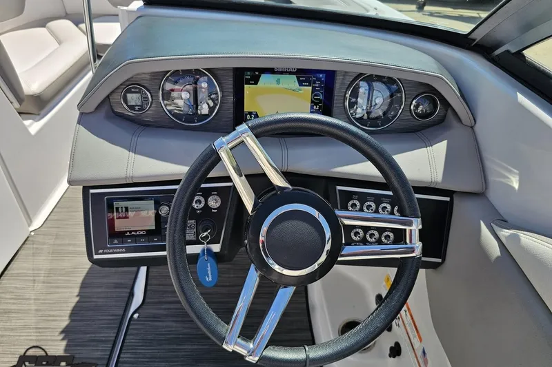 Slide: The Image of 2018 Four Winns HD220 boat dashboard with steering wheel and control panel. - 74
