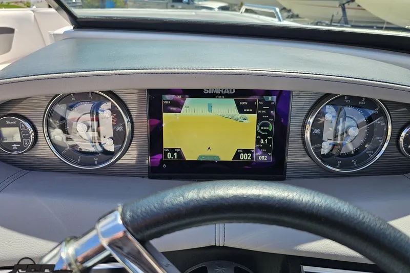 Slide: The Image of Dashboard of a 2018 Four Winns HD220 boat with Simrad navigation display. - 76