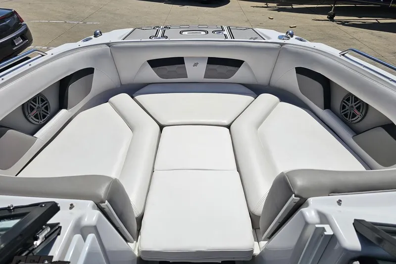 Slide: The Image of 2018 Four Winns HD220 boat interior with spacious white seating and speakers. - 79