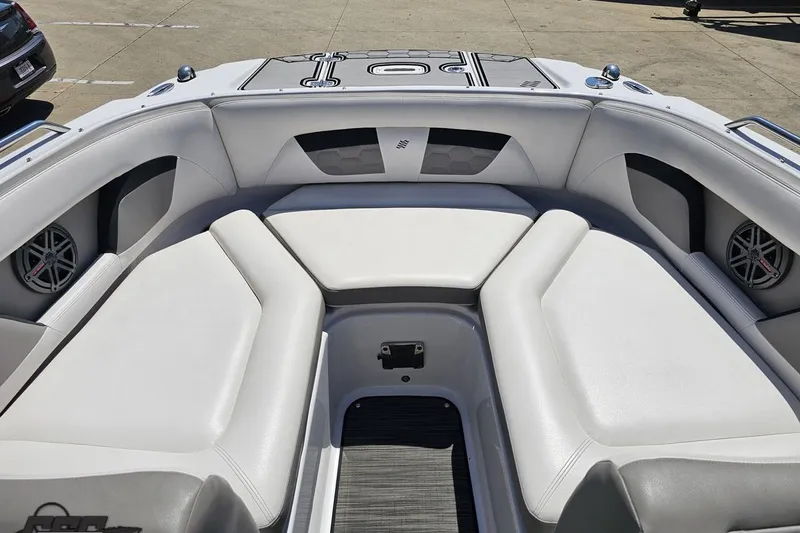 Slide: The Image of 2018 Four Winns HD220 boat interior with white cushioned seating and speakers. - 82