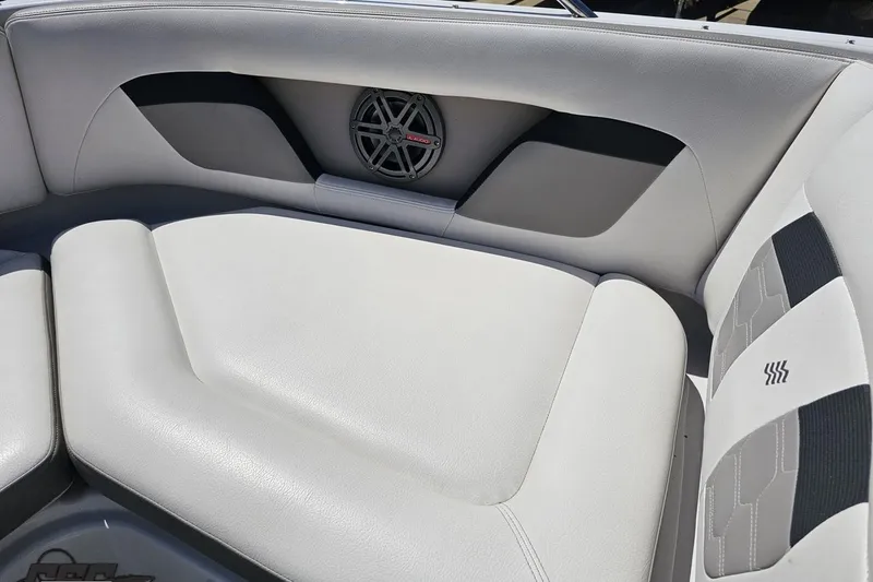 Slide: The Image of 2018 Four Winns HD220 boat interior with cushioned seating and speaker. - 85