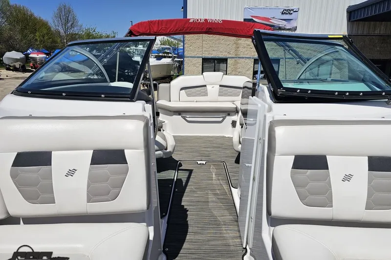 Slide: The Image of 2018 Four Winns HD220 boat interior with white seating and open windshield. - 89