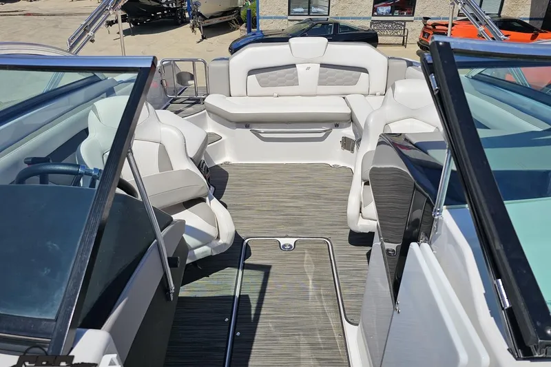 Slide: The Image of 2018 Four Winns HD220 boat interior with white seating and sleek design. - 90