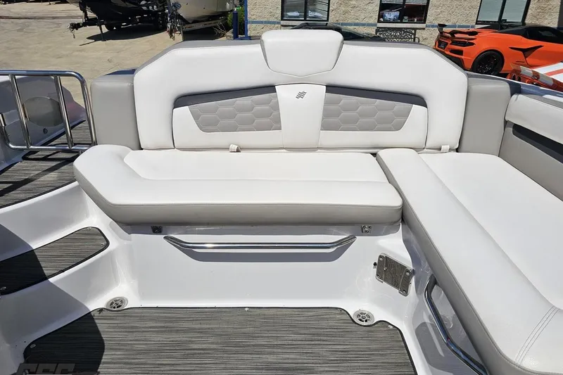 Slide: The Image of 2018 Four Winns HD220 boat interior with white cushioned seating and modern design. - 95