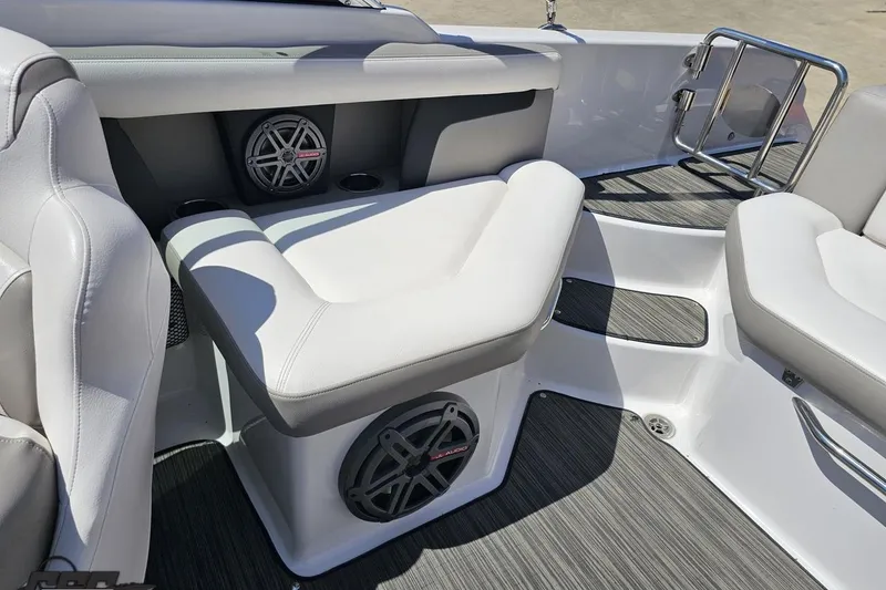 Slide: The Image of 2018 Four Winns HD220 boat interior with white seating and built-in speakers. - 96