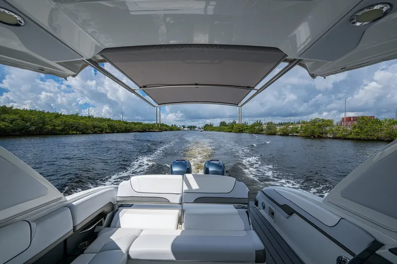 Slide: The Image of 2022 Formula 310 Bowrider OB cruising on a scenic waterway under a cloudy sky. - 51