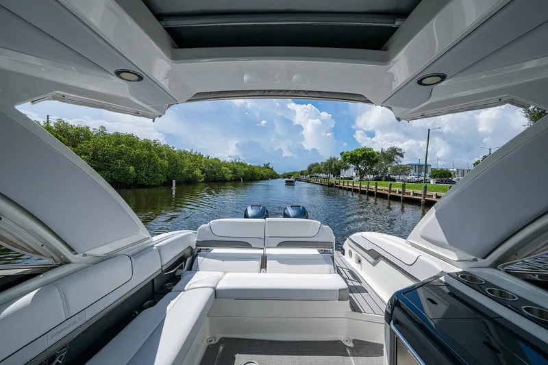 Slide: The Image of 2022 Formula 310 Bowrider OB cruising on a scenic waterway with lush greenery. - 47