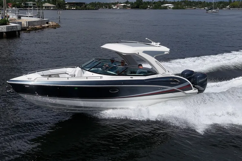 The Image of 2022 Formula 310 Bowrider OB cruising on a scenic waterway. - 0