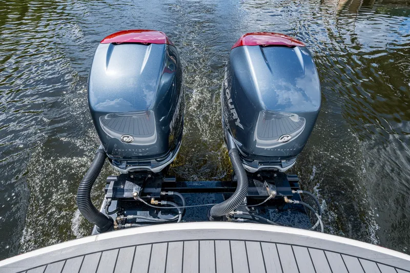 Slide: The Image of Twin outboard motors on a 2022 Formula 310 Bowrider OB in water. - 35