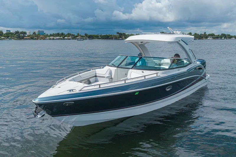 Slide: The Image of 2022 Formula 310 Bowrider OB cruising on a calm lake under cloudy skies. - 8