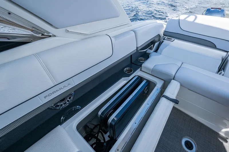 Slide: The Image of 2022 Formula 310 Bowrider OB interior with storage compartment and seating, on water. - 62
