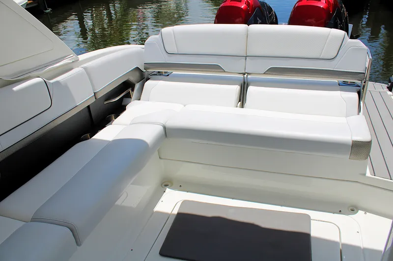 Slide: The Image of 2022 Formula 310 Bowrider OB interior with white seating and dual outboard engines. - 10
