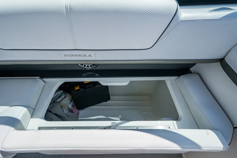 Slide: The Image of 2022 Formula 310 Bowrider OB storage compartment with white cushioned seating. - 63