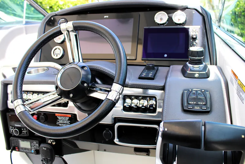 Slide: The Image of 2022 Formula 310 Bowrider OB dashboard with steering wheel and control panels. - 12