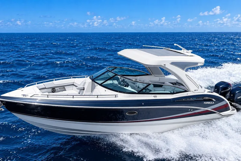 Slide: The Image of 2022 Formula 310 Bowrider OB cruising on open ocean waters. - 1