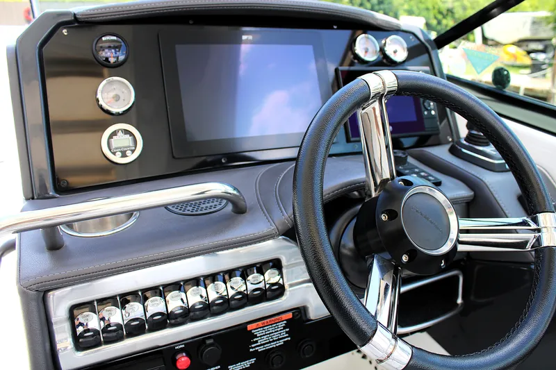 Slide: The Image of Steering console of 2022 Formula 310 Bowrider OB with modern controls and touchscreen display. - 13