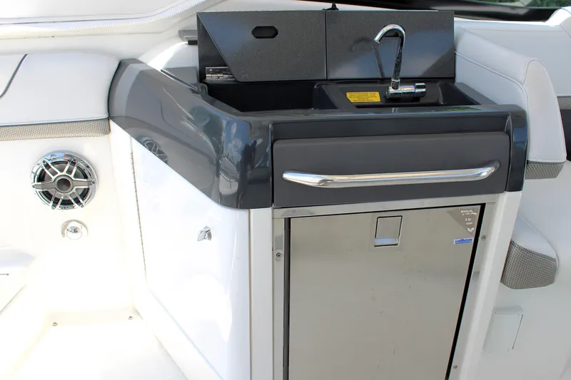 Slide: The Image of 2022 Formula 310 Bowrider OB boat interior with sink and storage area. - 16