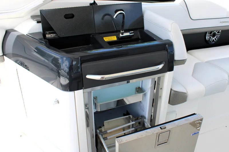 Slide: The Image of 2022 Formula 310 Bowrider OB boat interior with sink and storage compartment. - 17