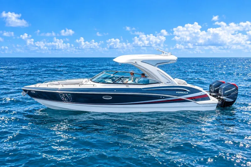 The Image of 2022 Formula 310 Bowrider OB cruising on open ocean under clear blue sky. - 0