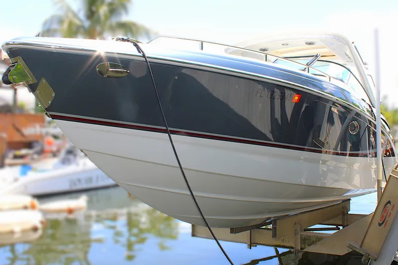 Slide: The Image of 2022 Formula 310 Bowrider OB boat docked, showcasing sleek design and modern features. - 2
