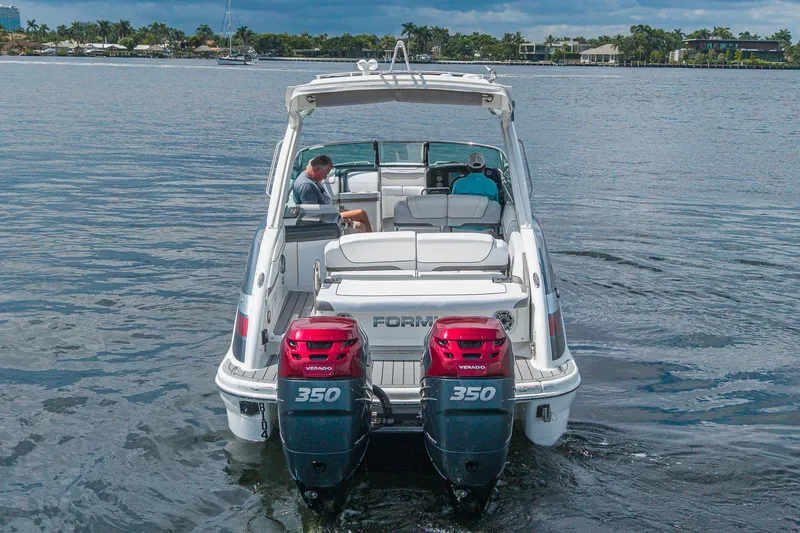 Slide: The Image of 2022 Formula 310 Bowrider OB with dual 350 Verado engines on a calm lake. - 12