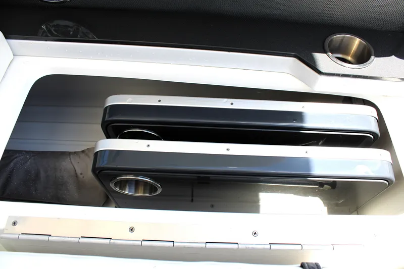 Slide: The Image of Storage compartment in 2022 Formula 310 Bowrider OB boat, featuring cup holders. - 23