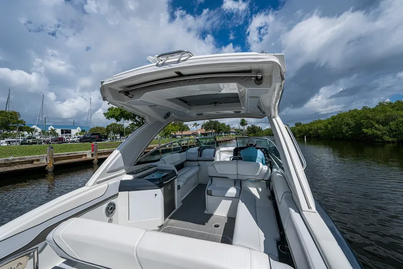 Slide: The Image of 2022 Formula 310 Bowrider OB on a scenic waterway under a partly cloudy sky. - 42