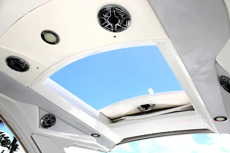 Slide: The Image of 2022 Formula 310 Bowrider OB boat roof with speakers and open sky view. - 26
