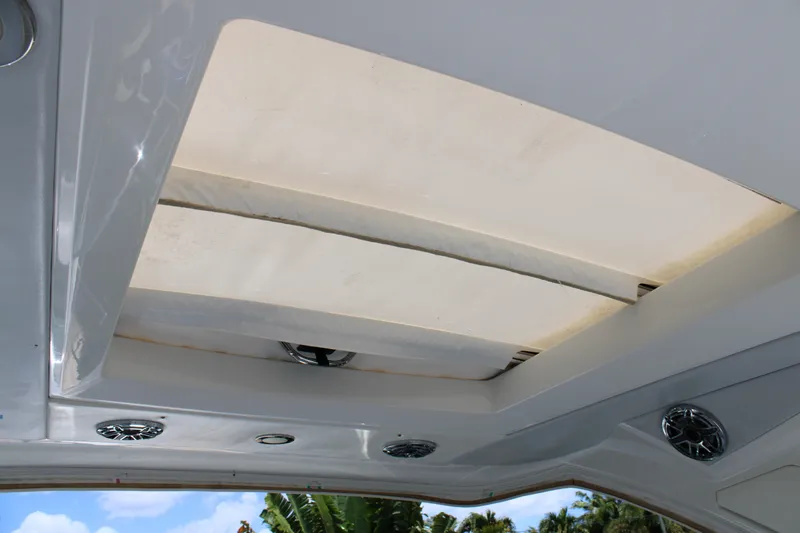 Slide: The Image of 2022 Formula 310 Bowrider OB boat interior ceiling with speakers and skylight. - 27