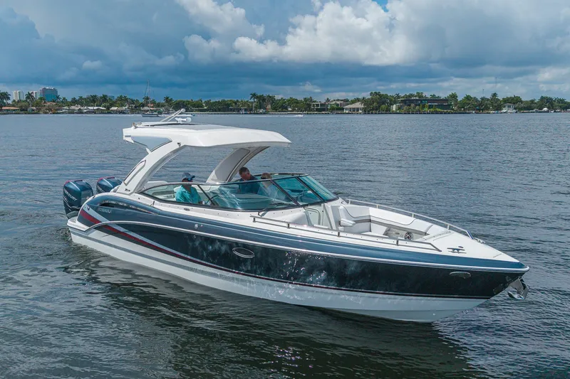 Slide: The Image of 2022 Formula 310 Bowrider OB cruising on a calm lake under a cloudy sky. - 5
